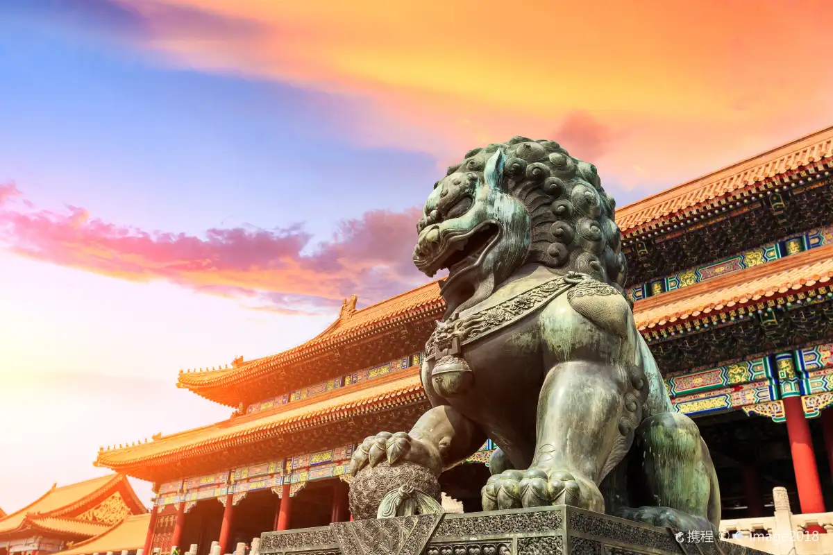 Bronze guardian lion statue at sunset